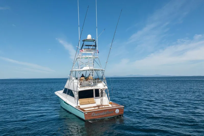 Scandaloso Yacht Photos Pics 2006 Viking 56 yacht on open sea under clear blue sky.