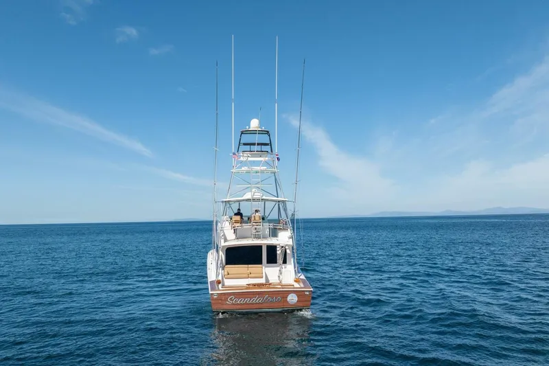 Scandaloso Yacht Photos Pics 2006 Viking 56 yacht on open sea under clear blue sky.