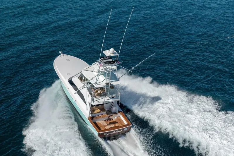 Scandaloso Yacht Photos Pics 2006 Viking 56 yacht cruising on open ocean, aerial view.