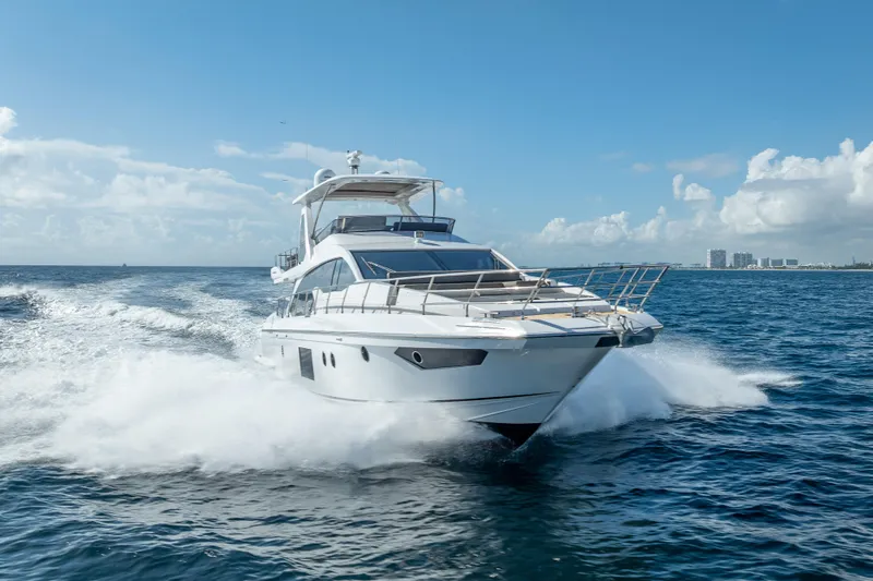  Yacht Photos Pics Luxurious 2019 Azimut 66 yacht cruising on open sea under clear blue sky.