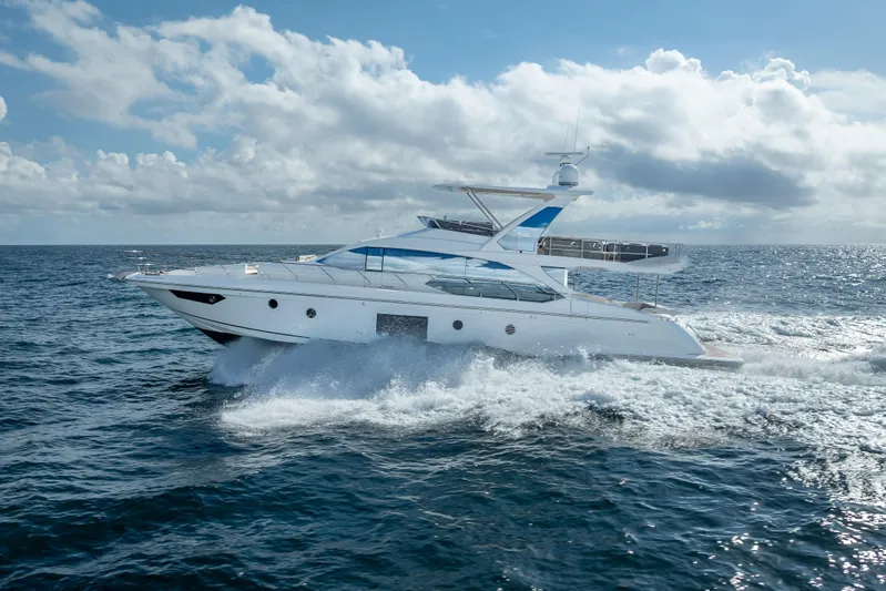  Yacht Photos Pics Luxurious 2019 Azimut 66 yacht cruising on open sea under a partly cloudy sky.