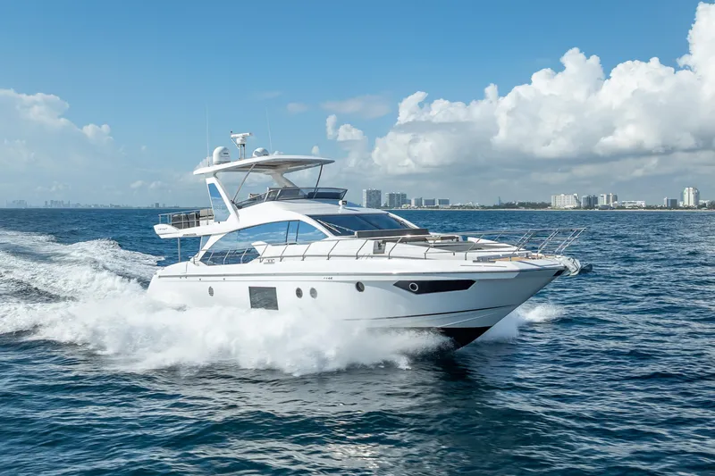  Yacht Photos Pics 2019 Azimut 66 yacht cruising on open water under a clear blue sky.