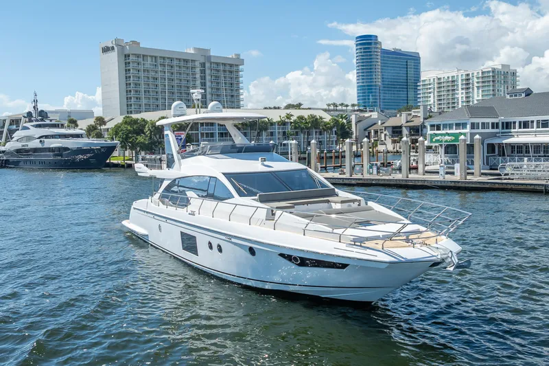  Yacht Photos Pics Luxury 2019 Azimut 66 yacht docked in a marina with modern buildings in the background.