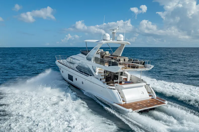  Yacht Photos Pics 2019 Azimut 66 yacht cruising on open sea under blue sky.