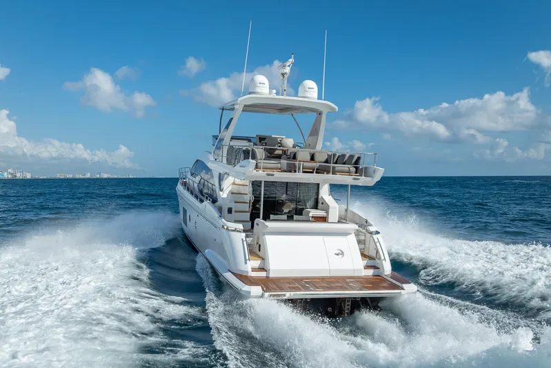  Yacht Photos Pics Luxury 2019 Azimut 66 yacht cruising on open sea under clear blue sky.
