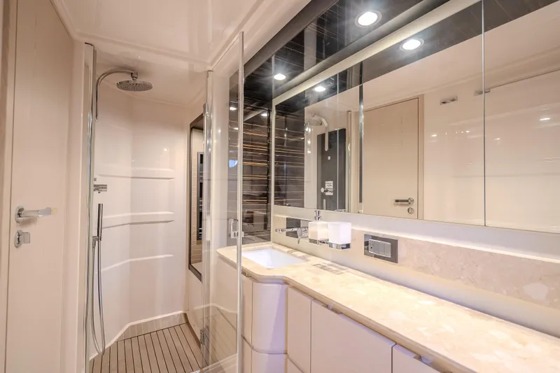  Yacht Photos Pics Luxurious bathroom interior of 2019 Azimut 66 yacht with modern shower and elegant fixtures.
