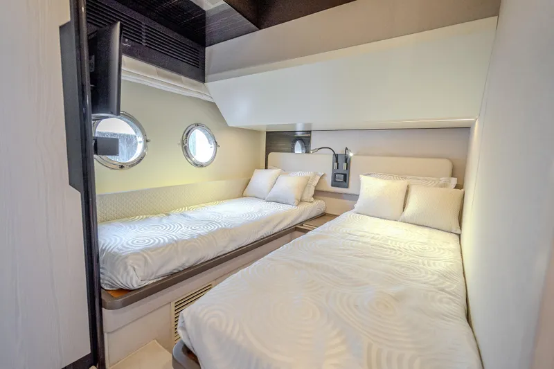  Yacht Photos Pics Luxurious 2019 Azimut 66 yacht cabin with twin beds and porthole windows.
