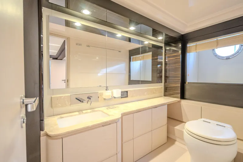  Yacht Photos Pics Luxurious bathroom in 2019 Azimut 66 yacht with modern fixtures and elegant design.