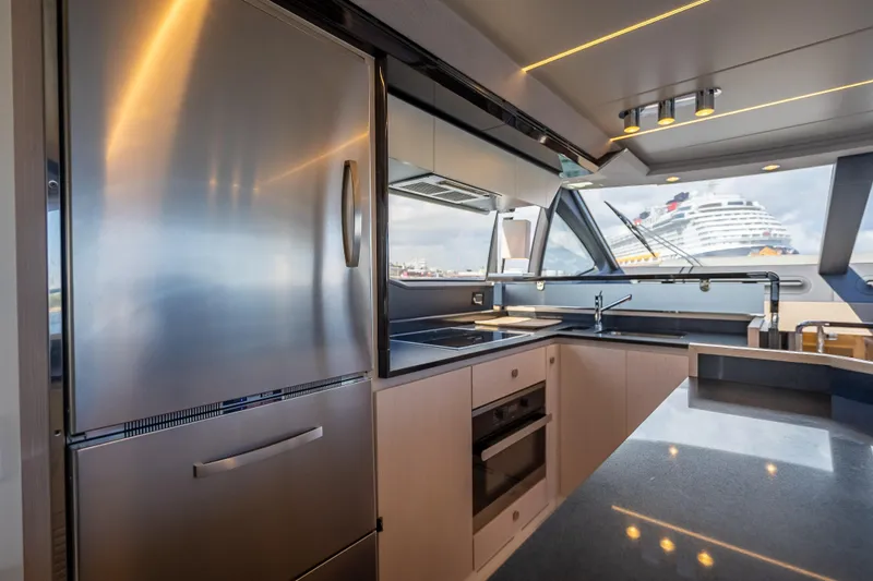  Yacht Photos Pics Luxurious kitchen interior of 2019 Azimut 66 yacht with modern appliances and ocean view.