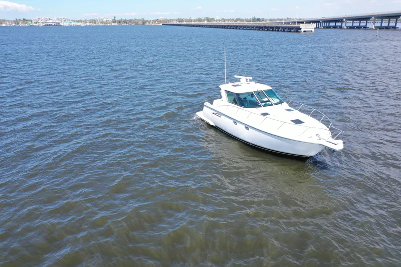  Yacht Photos Pics 2019 Tiara Yachts Sovran cruising on open water under clear skies.