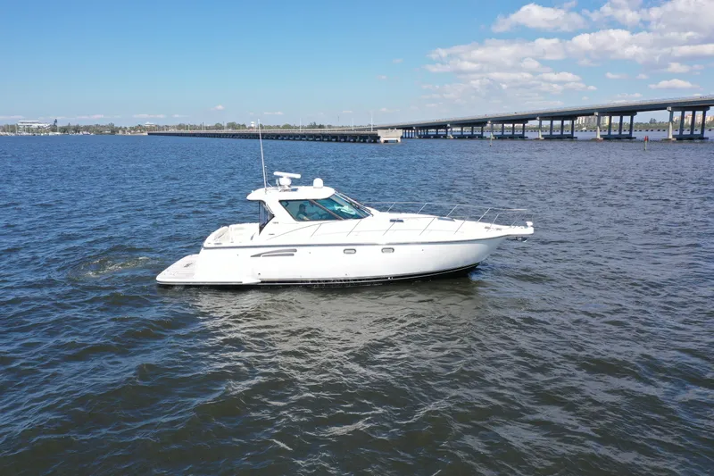  Yacht Photos Pics 2019 Tiara Yachts Sovran cruising on open water near a bridge under a clear sky.