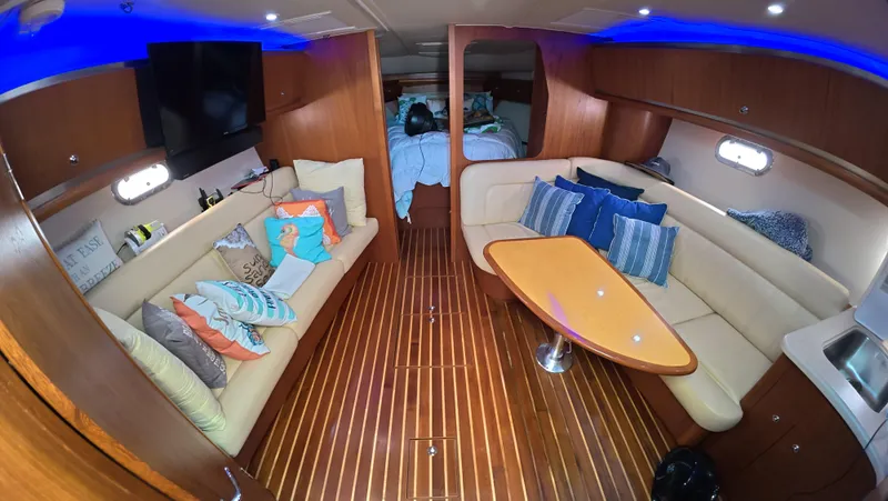  Yacht Photos Pics Luxurious interior of 2019 Tiara Yachts Sovran with plush seating and elegant wood flooring.
