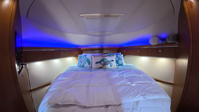  Yacht Photos Pics Luxurious 2019 Tiara Yachts Sovran cabin with ambient lighting and plush bedding.