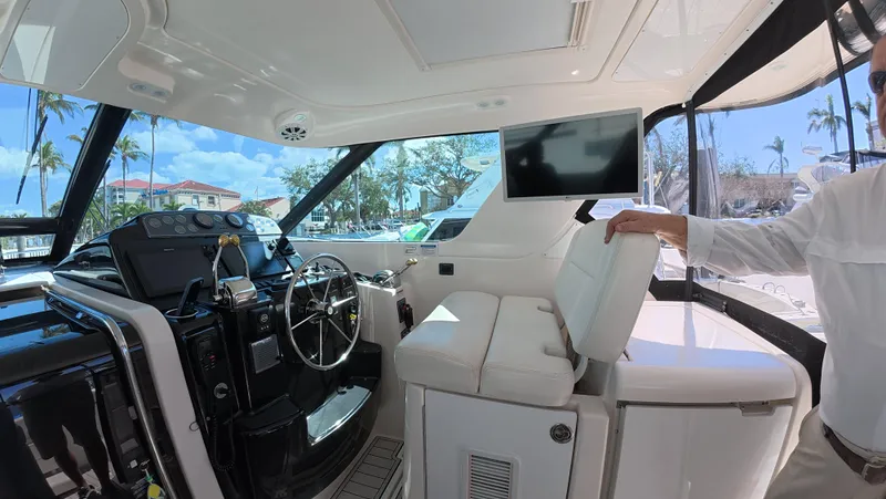  Yacht Photos Pics Interior of 2019 Tiara Yachts Sovran, featuring helm, seating, and modern navigation equipment.
