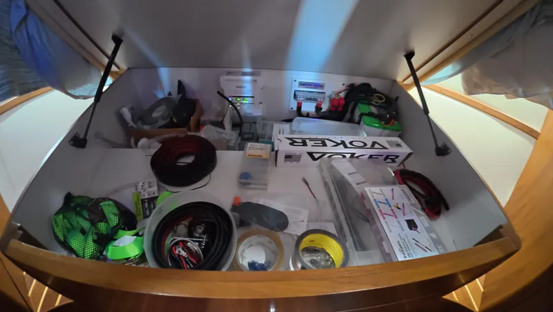 Yacht Photos Pics Storage compartment in 2019 Tiara Yachts Sovran, filled with various tools and supplies.