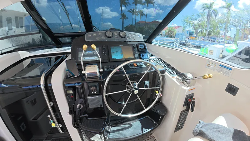  Yacht Photos Pics 2019 Tiara Yachts Sovran helm with steering wheel and navigation controls.