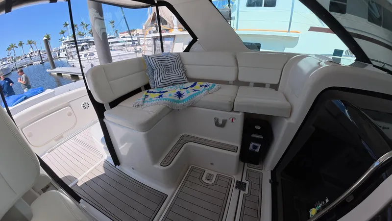  Yacht Photos Pics 2019 Tiara Yachts Sovran interior with plush seating and marina view.