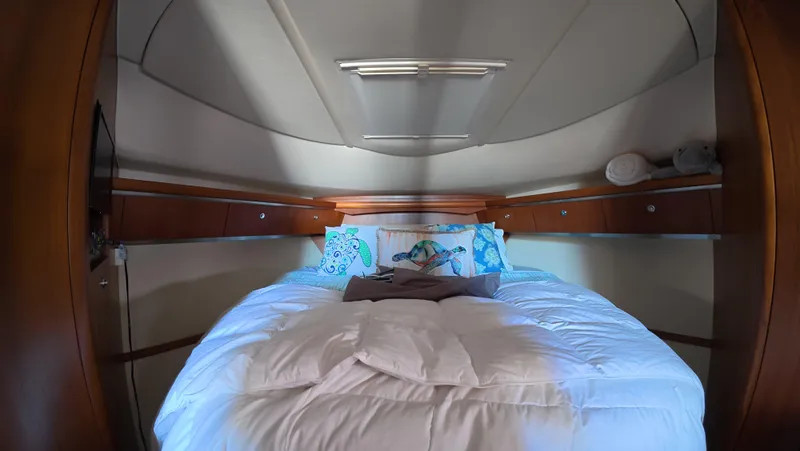 Yacht Photos Pics Luxurious bedroom interior of 2019 Tiara Yachts Sovran with cozy bedding.