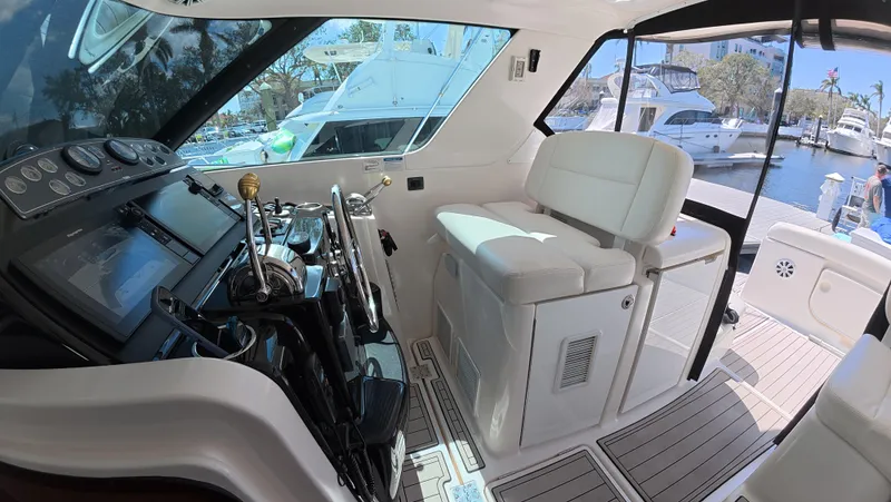  Yacht Photos Pics 2019 Tiara Yachts Sovran interior with helm and seating, docked at marina.