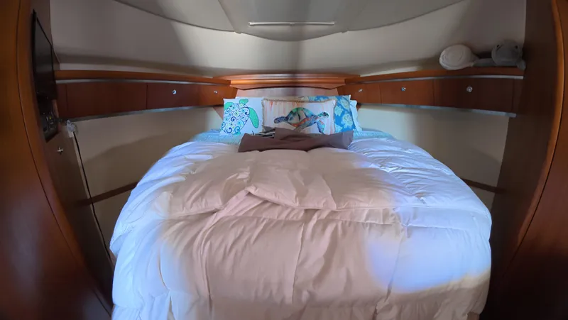  Yacht Photos Pics Luxurious 2019 Tiara Yachts Sovran cabin with cozy bedding and elegant wood accents.