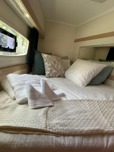 Vahevala Yacht Photos Pics Cozy cabin interior of 2019 Fountaine Pajot Lucia 40 with neatly arranged bedding.