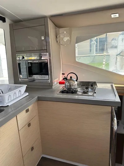 Vahevala Yacht Photos Pics Interior of 2019 Fountaine Pajot Lucia 40 yacht kitchen with stove and microwave.