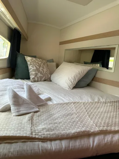 Vahevala Yacht Photos Pics Cozy cabin interior of 2019 Fountaine Pajot Lucia 40 with plush bedding and elegant decor.