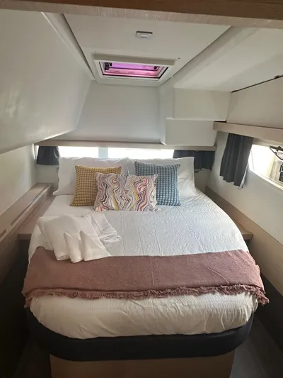 Vahevala Yacht Photos Pics Cozy bedroom in 2019 Fountaine Pajot Lucia 40 catamaran with colorful pillows and soft lighting.