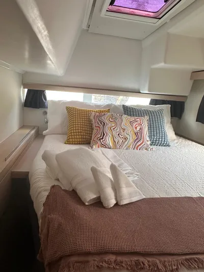 Vahevala Yacht Photos Pics Cozy cabin interior of 2019 Fountaine Pajot Lucia 40 with colorful pillows and soft linens.