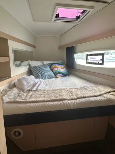 Vahevala Yacht Photos Pics Cozy cabin interior of 2019 Fountaine Pajot Lucia 40 catamaran with bed and window view.
