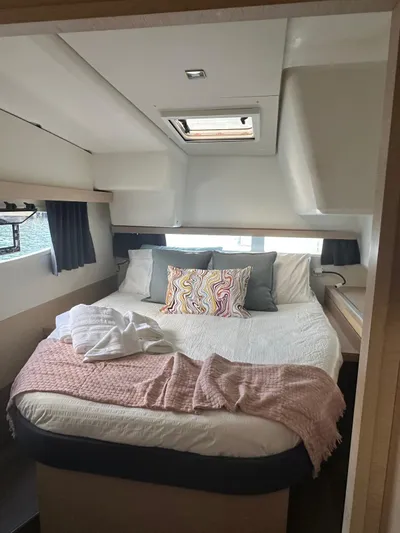 Vahevala Yacht Photos Pics Cozy bedroom interior of 2019 Fountaine Pajot Lucia 40 catamaran with skylight and plush bedding.
