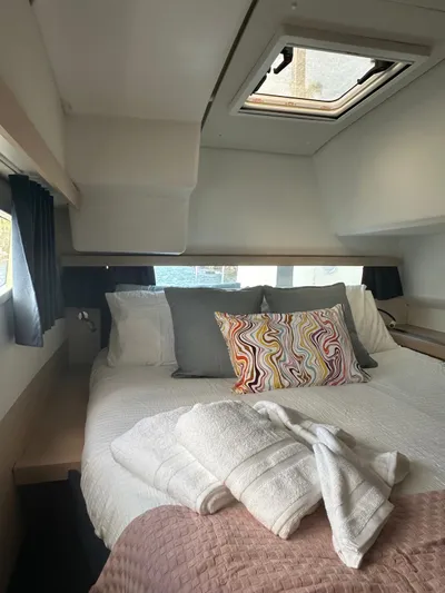 Vahevala Yacht Photos Pics Cozy cabin interior of 2019 Fountaine Pajot Lucia 40 with skylight and colorful pillow.