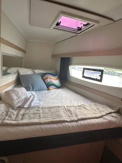 Vahevala Yacht Photos Pics Cozy cabin interior of 2019 Fountaine Pajot Lucia 40 catamaran with bed and window view.