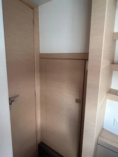 Vahevala Yacht Photos Pics Interior of 2019 Fountaine Pajot Lucia 40 yacht, featuring wooden cabinetry and door.
