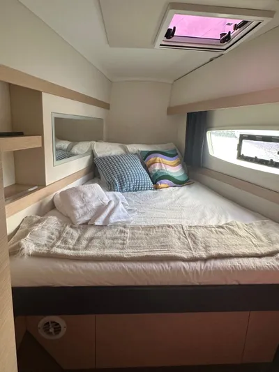 Vahevala Yacht Photos Pics Cozy cabin interior of 2019 Fountaine Pajot Lucia 40 catamaran with bed and window view.