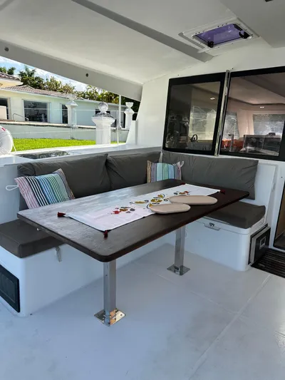 Vahevala Yacht Photos Pics 2019 Fountaine Pajot Lucia 40 yacht interior with dining area and cushioned seating.