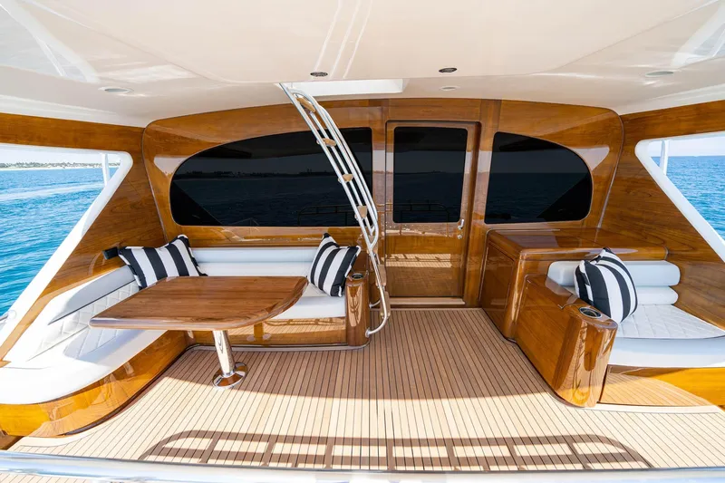 New Build Yacht Photos Pics Luxurious 2026 Viking 90 Sky Bridge yacht interior with elegant wood finish and striped cushions.