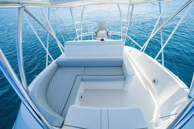 New Build Yacht Photos Pics Luxurious seating area on 2026 Viking 90 Sky Bridge yacht, overlooking serene ocean waters.