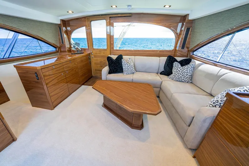 New Build Yacht Photos Pics Luxurious interior of 2026 Viking 90 Sky Bridge yacht with elegant wood finishes and ocean view.