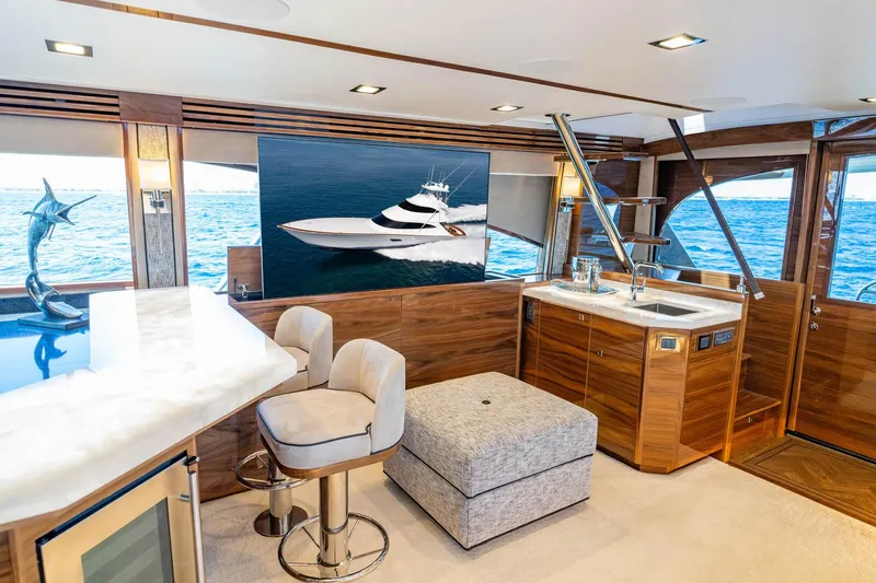 New Build Yacht Photos Pics Luxurious interior of 2026 Viking 90 Sky Bridge yacht with elegant wood finishes.
