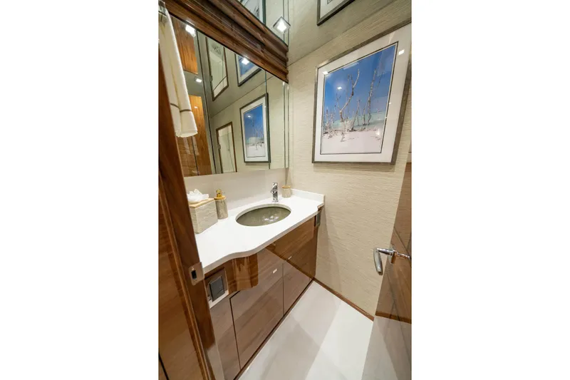 New Build Yacht Photos Pics Luxurious bathroom in 2026 Viking 90 Sky Bridge yacht with modern fixtures and elegant decor.