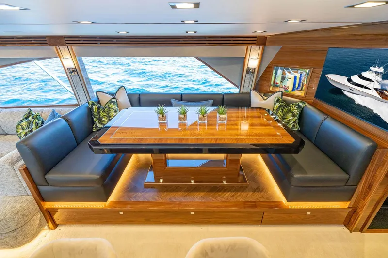New Build Yacht Photos Pics Luxurious interior of 2026 Viking 90 Sky Bridge yacht with elegant dining area and ocean view.