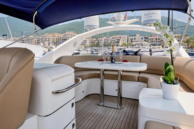  Yacht Photos Pics Luxurious 2009 Princess 23M yacht interior with elegant seating, table, and scenic marina view.