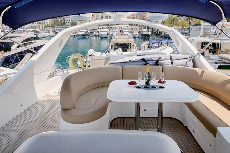  Yacht Photos Pics Luxurious 2009 Princess 23M yacht interior with elegant seating, table, and champagne setup in marina.