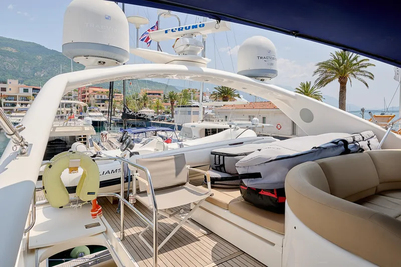  Yacht Photos Pics Luxurious 2009 Princess 23M yacht interior with seating, docked in a scenic marina.