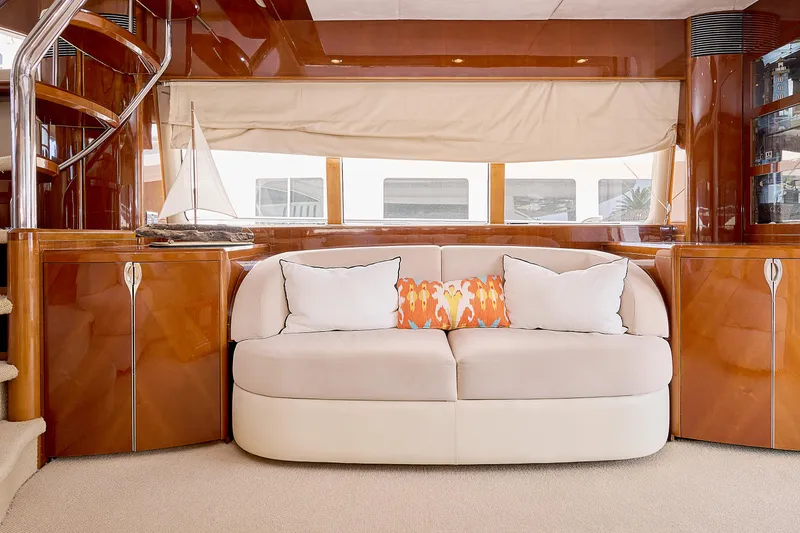  Yacht Photos Pics Luxurious yacht interior with elegant sofa, wooden cabinetry, and decorative pillows, Princess 23M, 2009 model.