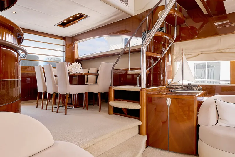  Yacht Photos Pics Luxurious interior of 2009 Princess 23M yacht with elegant dining area and spiral staircase.