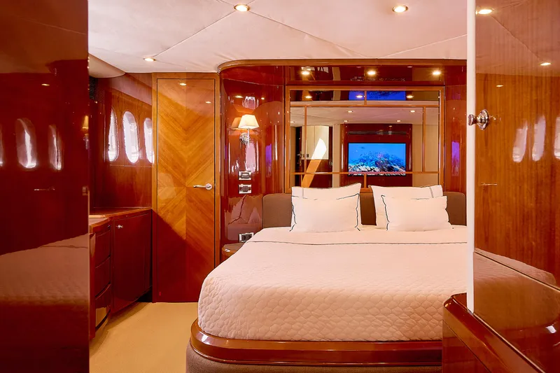  Yacht Photos Pics Luxurious yacht bedroom with wood paneling, plush bedding, and ambient lighting, Princess 23M, 2009.