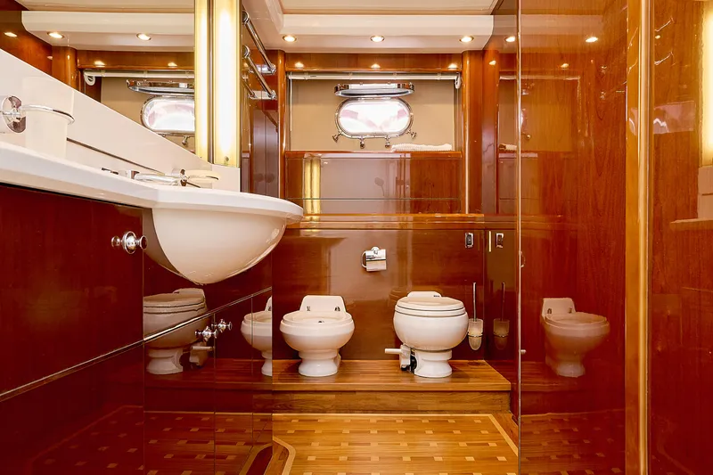 Yacht Photos Pics Luxurious yacht bathroom with wooden finishes, featuring a sink, toilet, and bidet. Princess 23M, 2009.