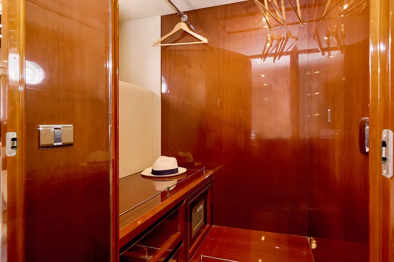 Yacht Photos Pics Luxurious wooden yacht interior closet with hangers and a hat, Princess 23M, 2009 model.